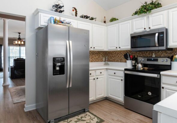 side-by-side refrigerator styling, open plan kitchen design, integrating refrigerator in living space, kitchen appliance decor ideas, modern open plan kitchen, refrigerator placement tips, open plan living tips, stylish kitchen appliances, kitchen design ideas, seamless appliance integration